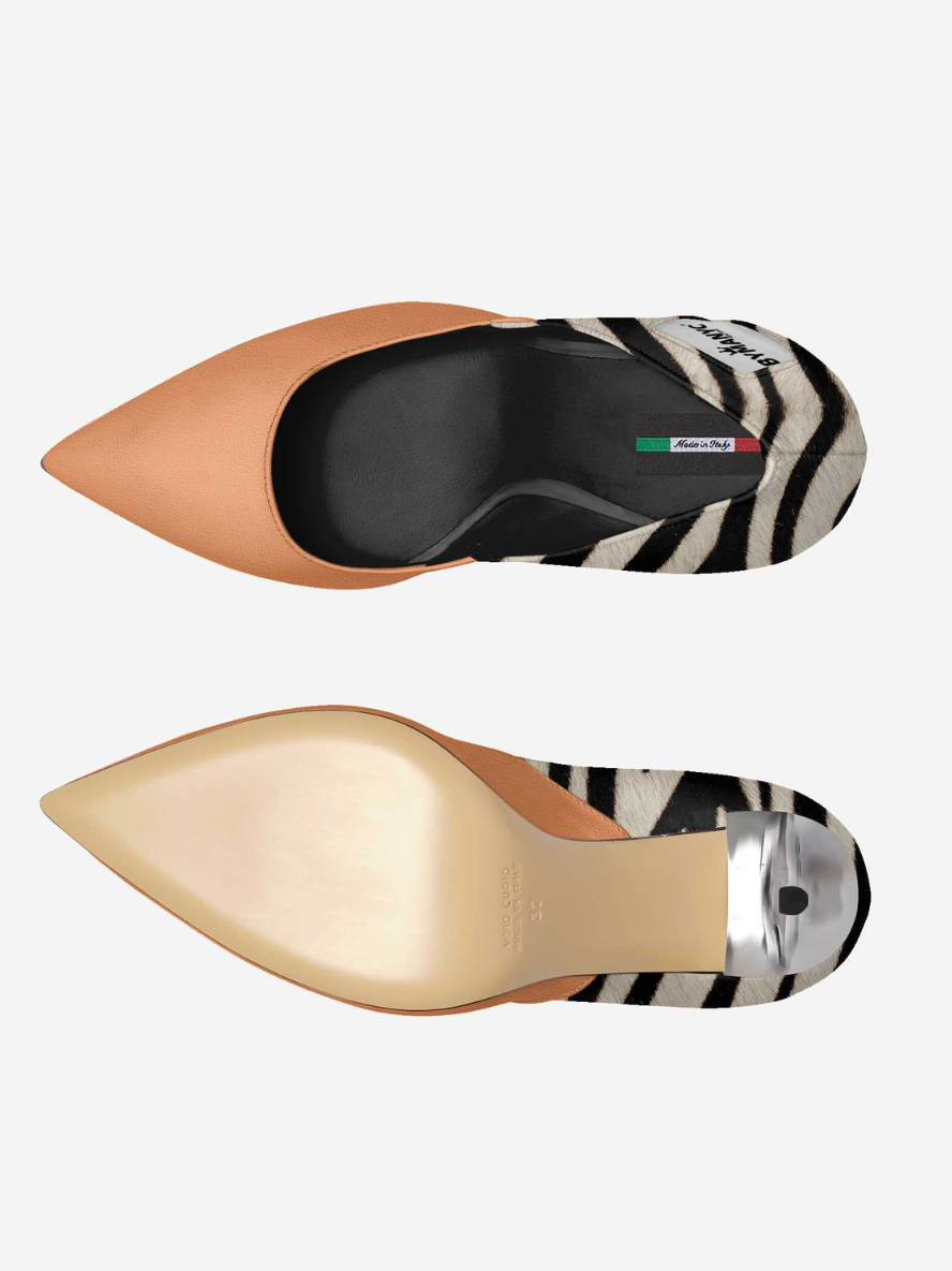 Two pairs of pointed-toe shoes with zebra print soles on a white background
