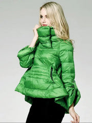 Woman wearing a green puffer jacket on a plain background