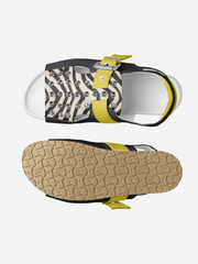 Black sandal with zebra pattern strap and yellow accents on a white background