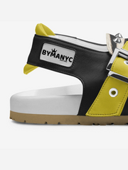 Black, white, and yellow sneaker with 'BYMANYC' branding on a white background