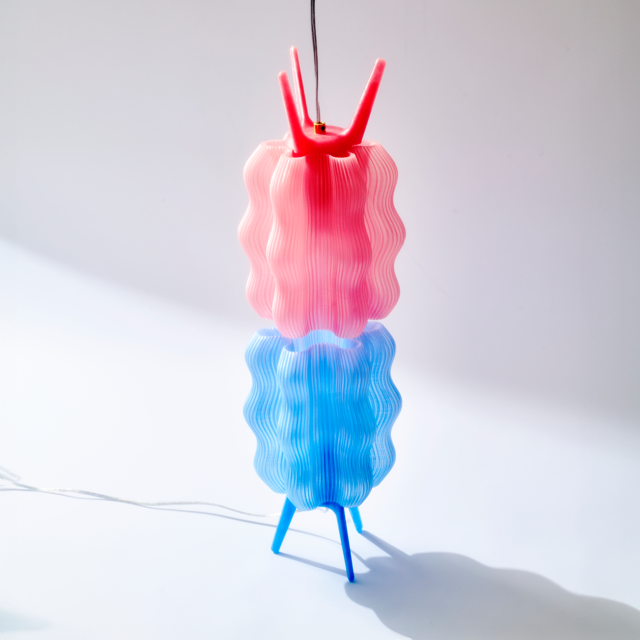 Colorful lamp with pink and blue design on a white background