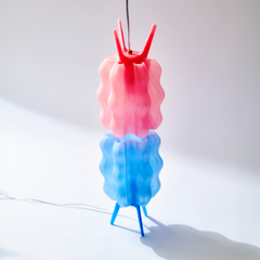 Colorful lamp with pink and blue design on a white background