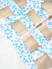 Close-up of a decorative mesh panel with blue and white beads on a beige background