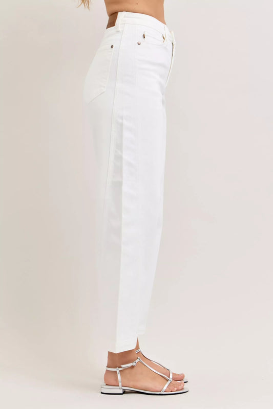 White jeans worn by a person on a light gray background