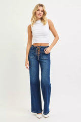 Woman wearing blue jeans and a white top on a white background