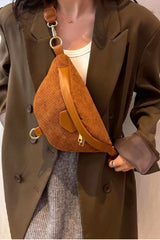 Person wearing a brown textured bag over one shoulder, with a neutral background