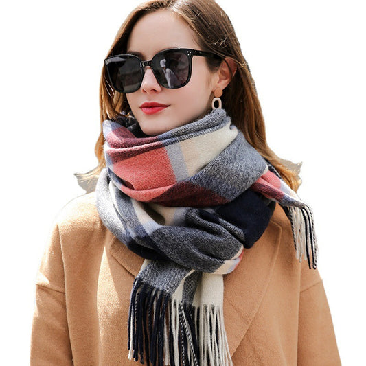 Woman wearing a plaid scarf, sunglasses, and a tan coat on a white background