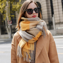 Woman wearing a colorful scarf and sunglasses on a city street