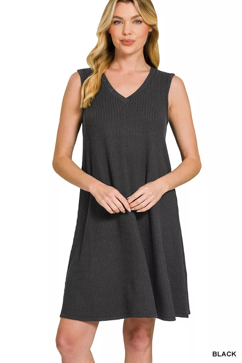 Woman wearing a black sleeveless dress on a white background