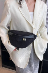 Person wearing a black waist bag with a neutral background