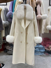 Cream-colored coat with fur trim in a clothing store setting