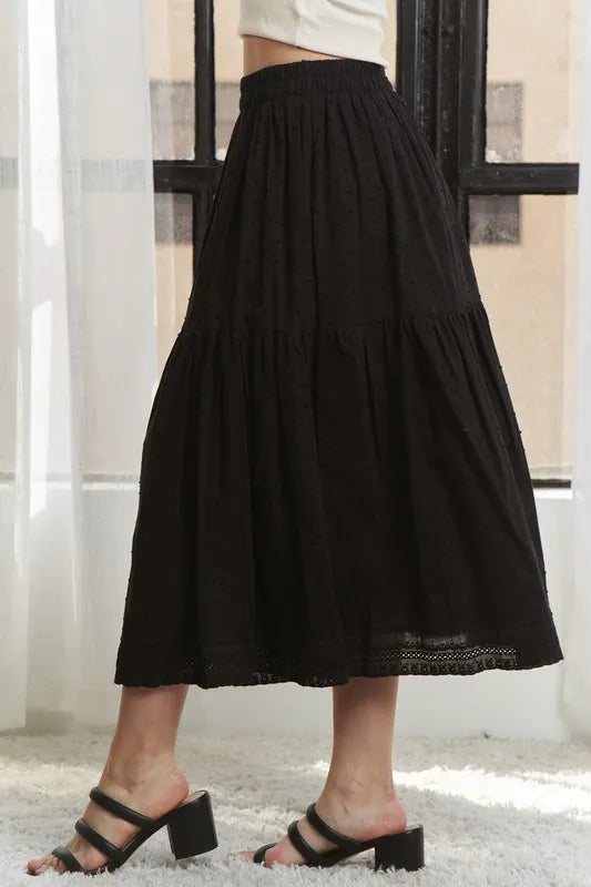 Person wearing a black skirt with a blurred background