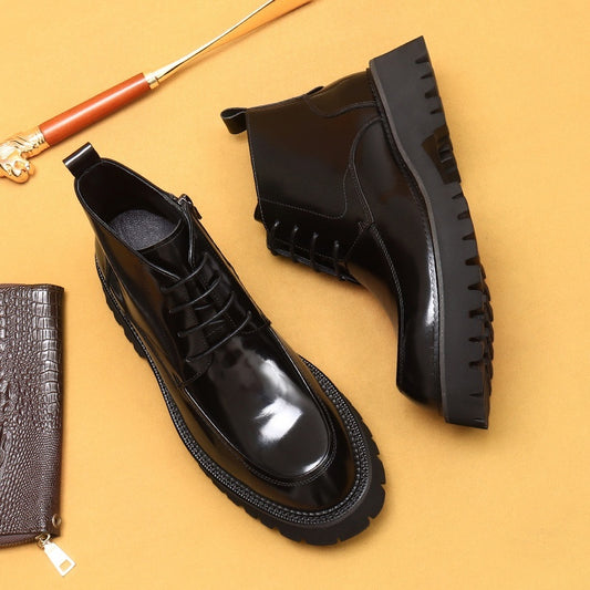 Black leather boots and wallet on a mustard yellow background