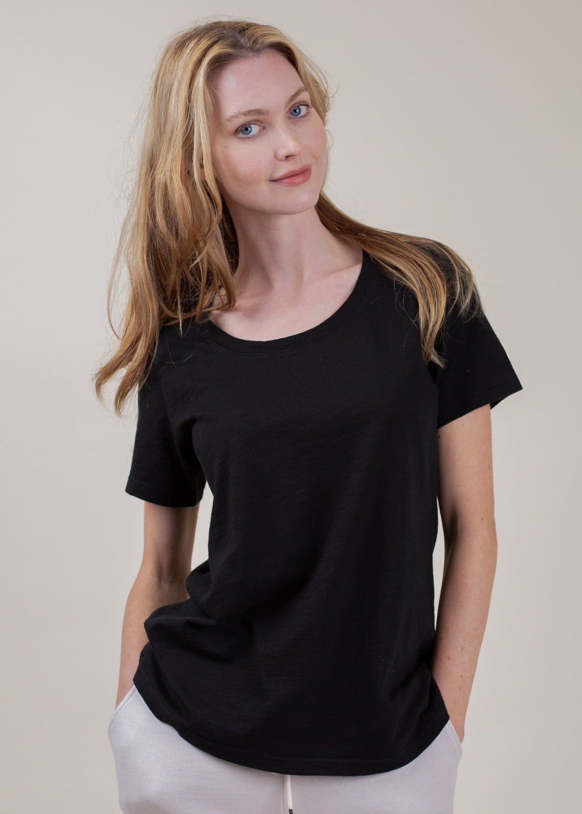 Woman wearing a black t-shirt against a plain background