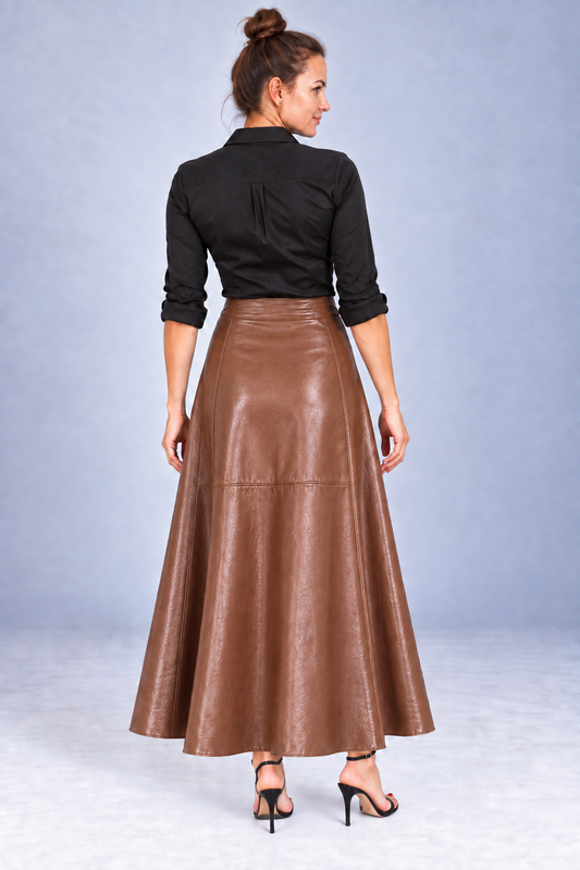 A woman shown from the back wearing a black long-sleeve blouse and a high-waisted, flared brown faux-leather skirt, paired with black high-heeled sandals, against a light gray studio backdrop.