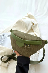 Green and brown waist bag held by a hand on a white background