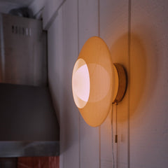 Yellow wall light fixture on a white wall