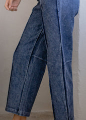 Blue denim pants on a plain background