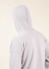Light gray hoodie on a beige background