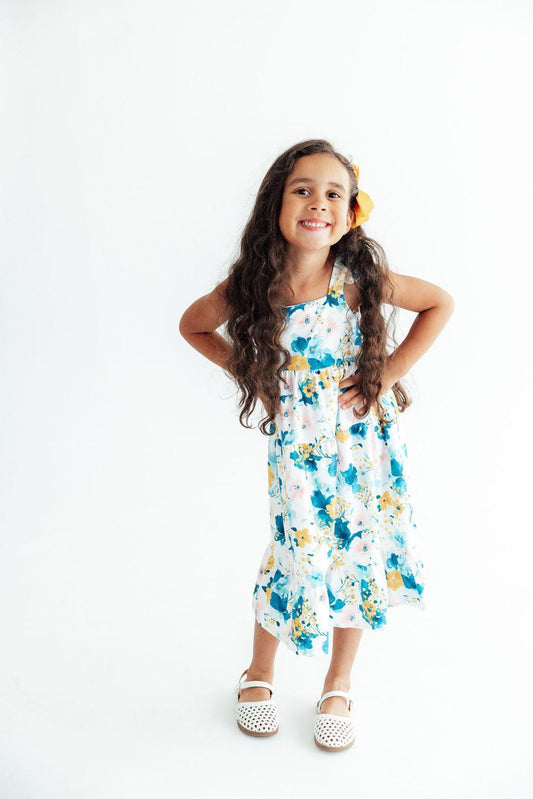 Young girl wearing a floral dress on a white background