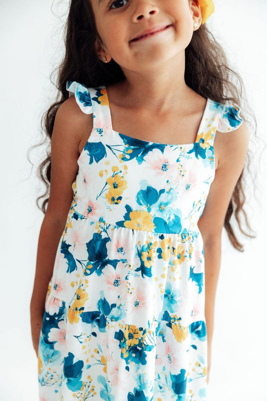Young girl wearing a floral dress with a white background