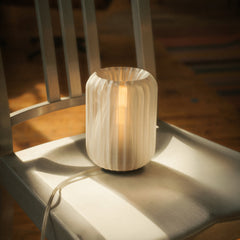 Wooden lamp on a chair with warm glow