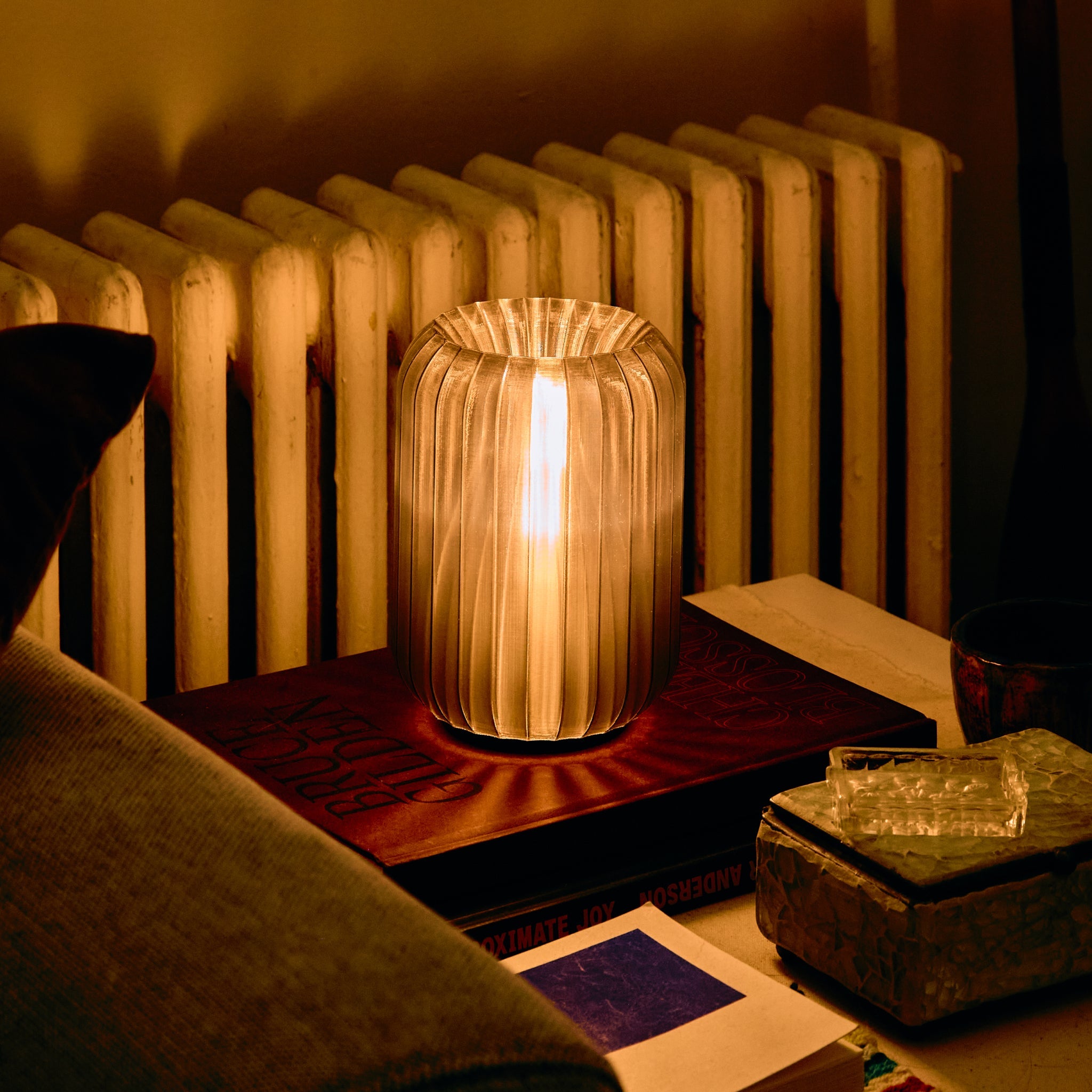 Decorative lamp on a table with a radiator in the background