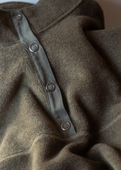 Close-up of a brown garment with button details