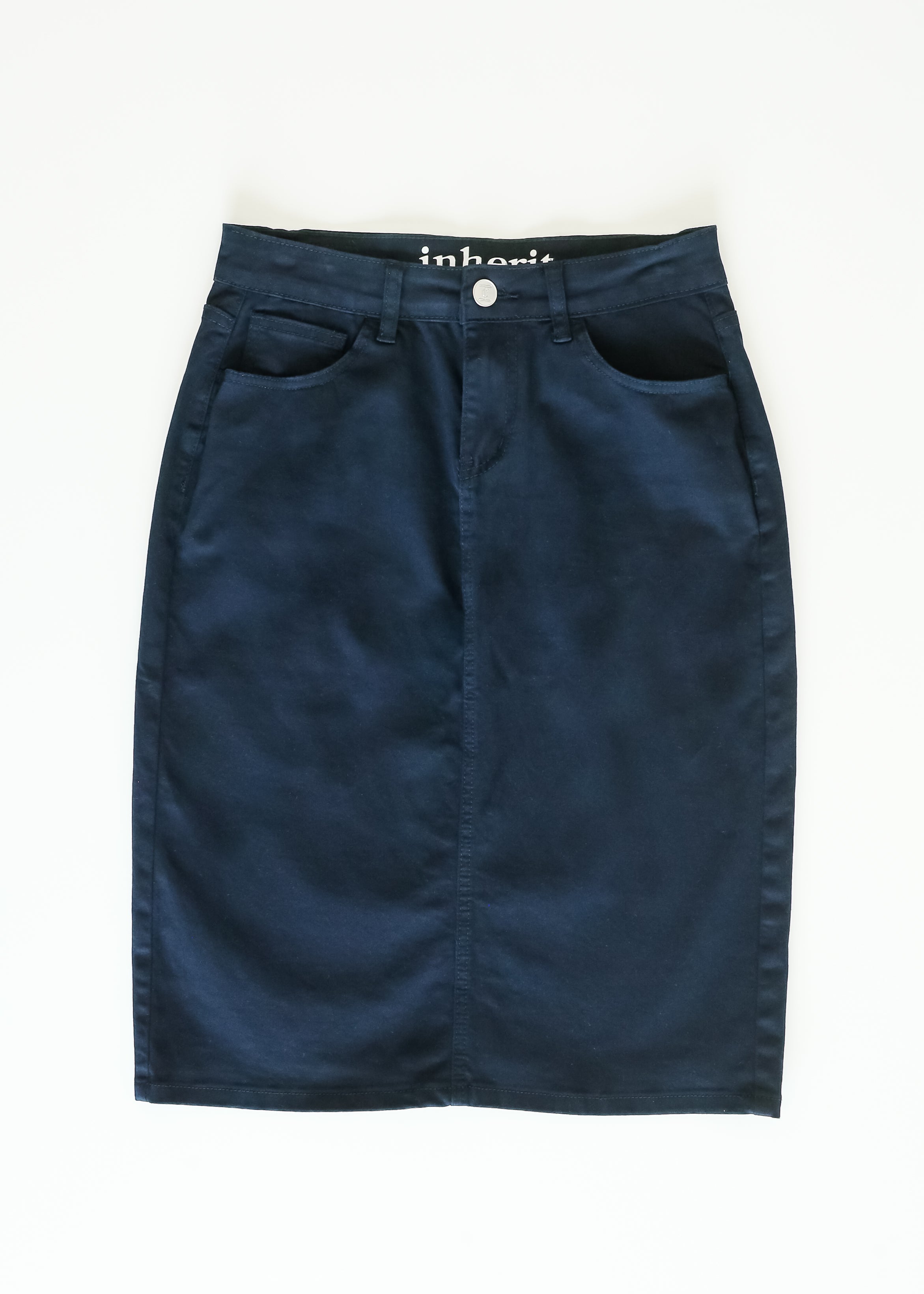 Navy blue denim skirt with 'inhabit' branding on a white background