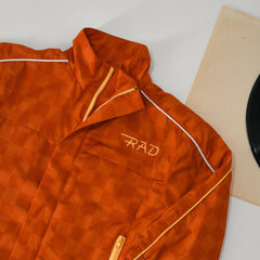 Orange checkered jacket with 'RAD' logo on a white surface